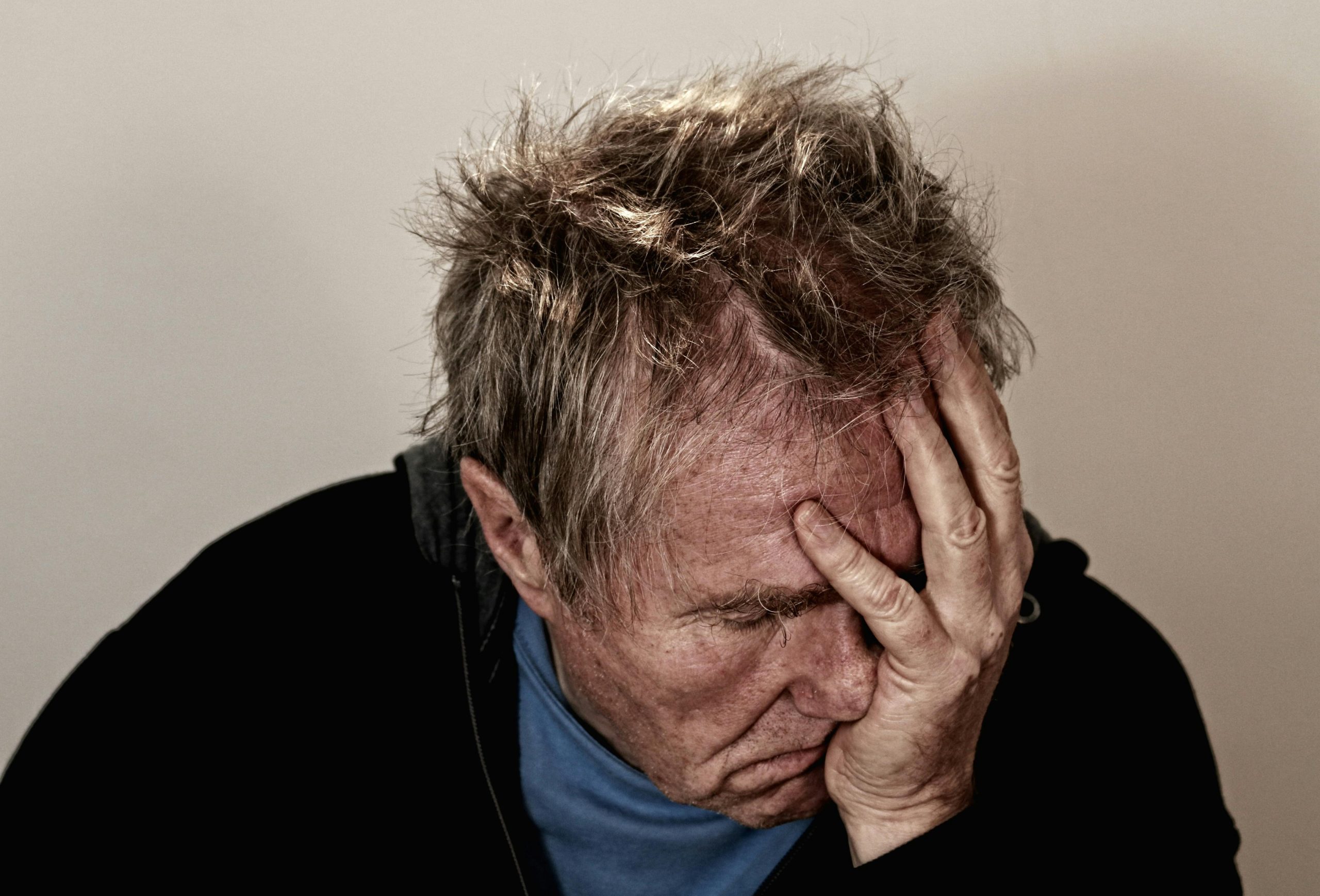 Man holding head from brain fog