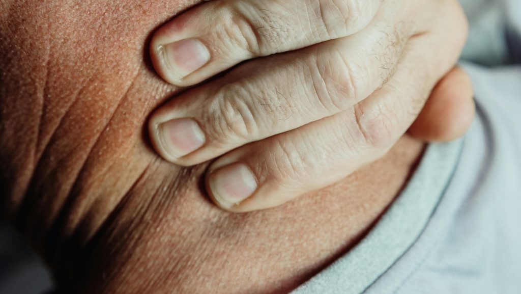 Person holding their neck