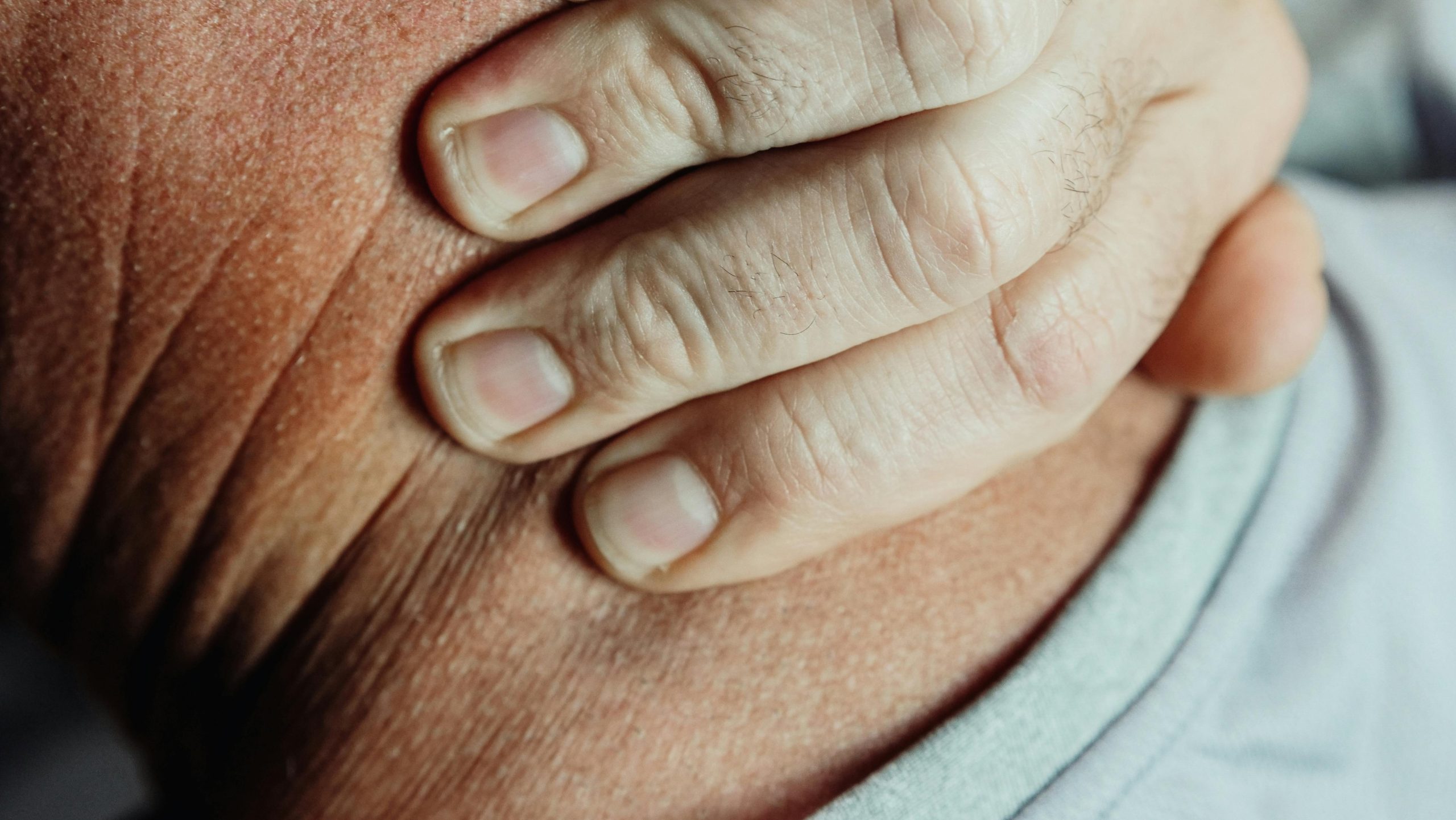 Person holding their neck