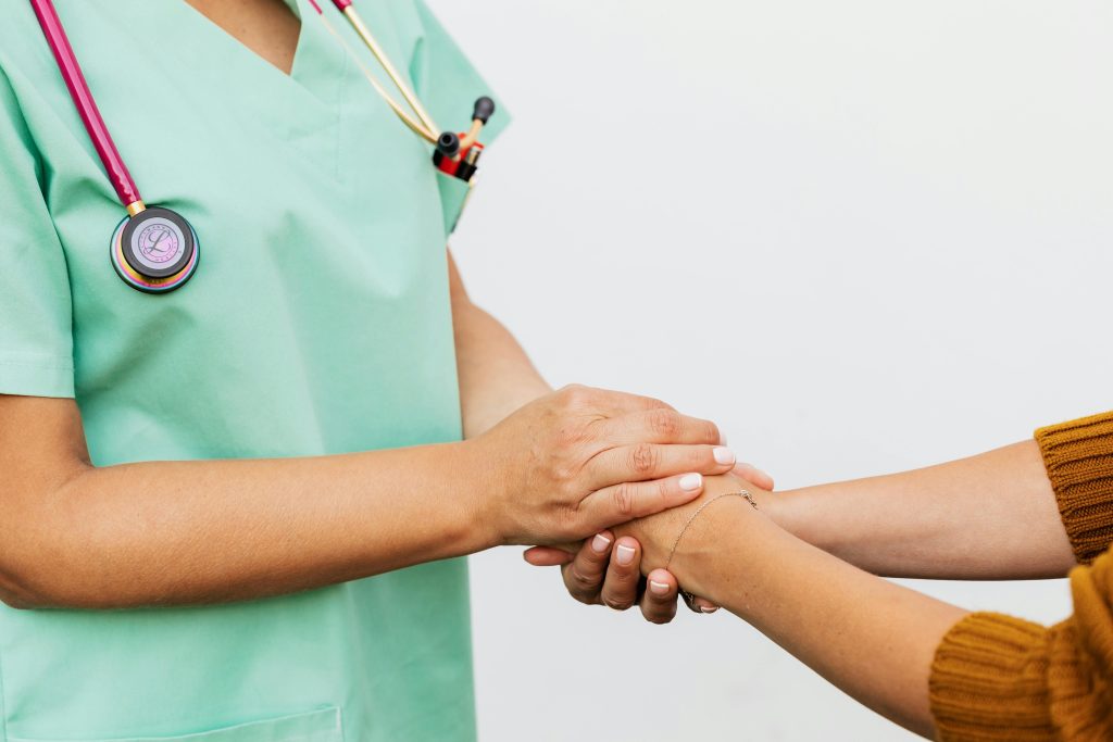 Doctor holding the hands of a another person